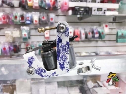 Photo of a white and purple floral pattern tattoo machine.