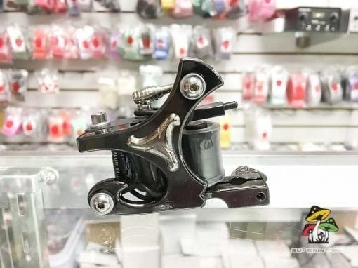 Photo of a black and silver tattoo machine.